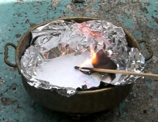 flower burning in improvised cauldron